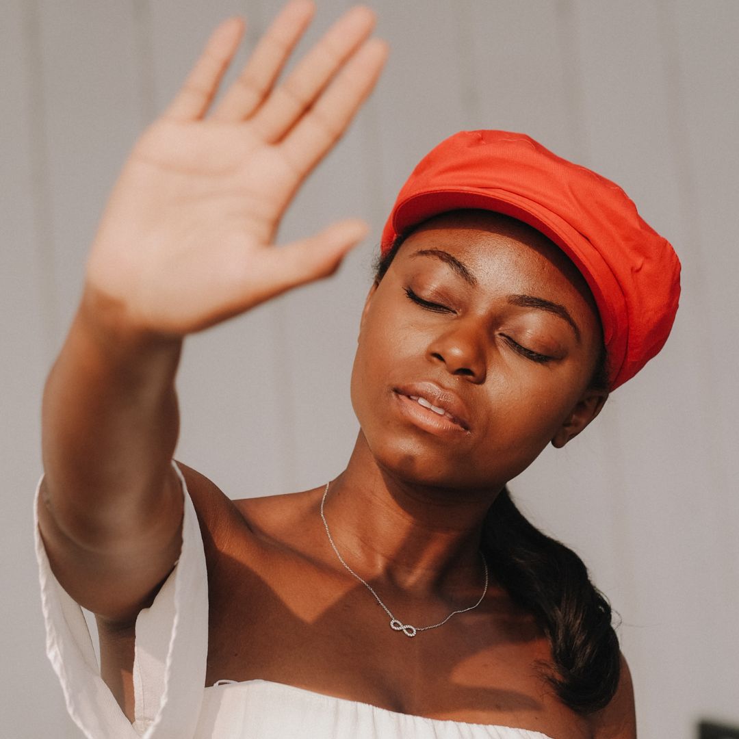 woman reaching to the sun