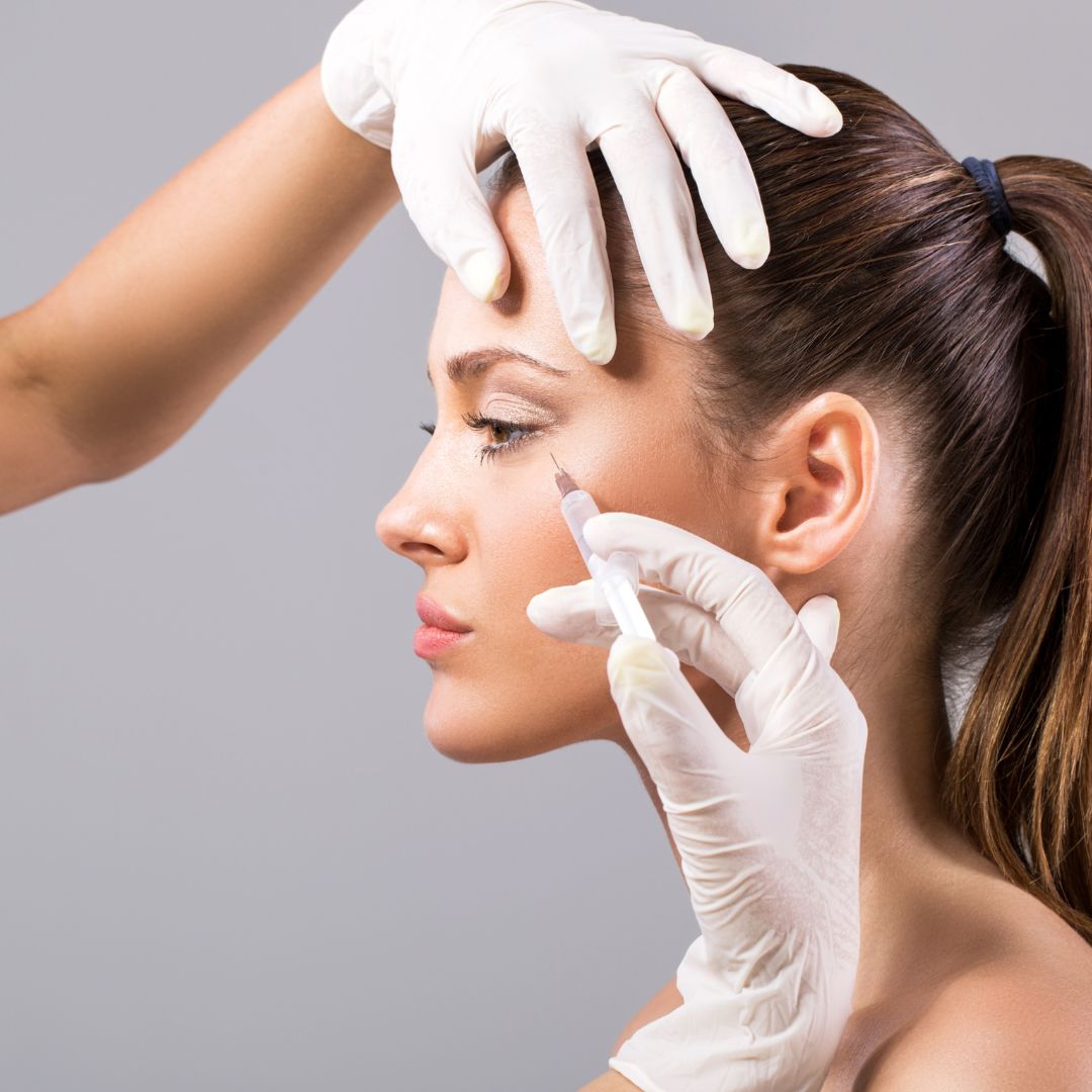Young woman getting botox in her crow's feet