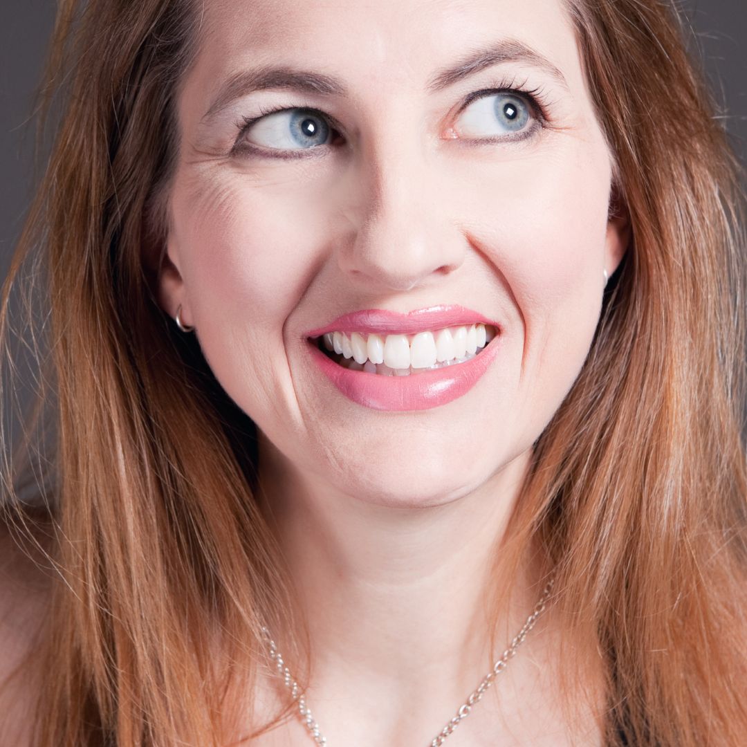 Woman smiling with smile lines and crow's feet 