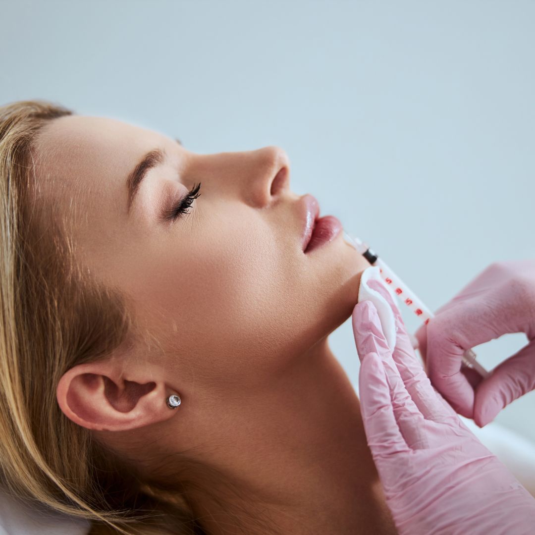 Side view of woman getting filler in lips