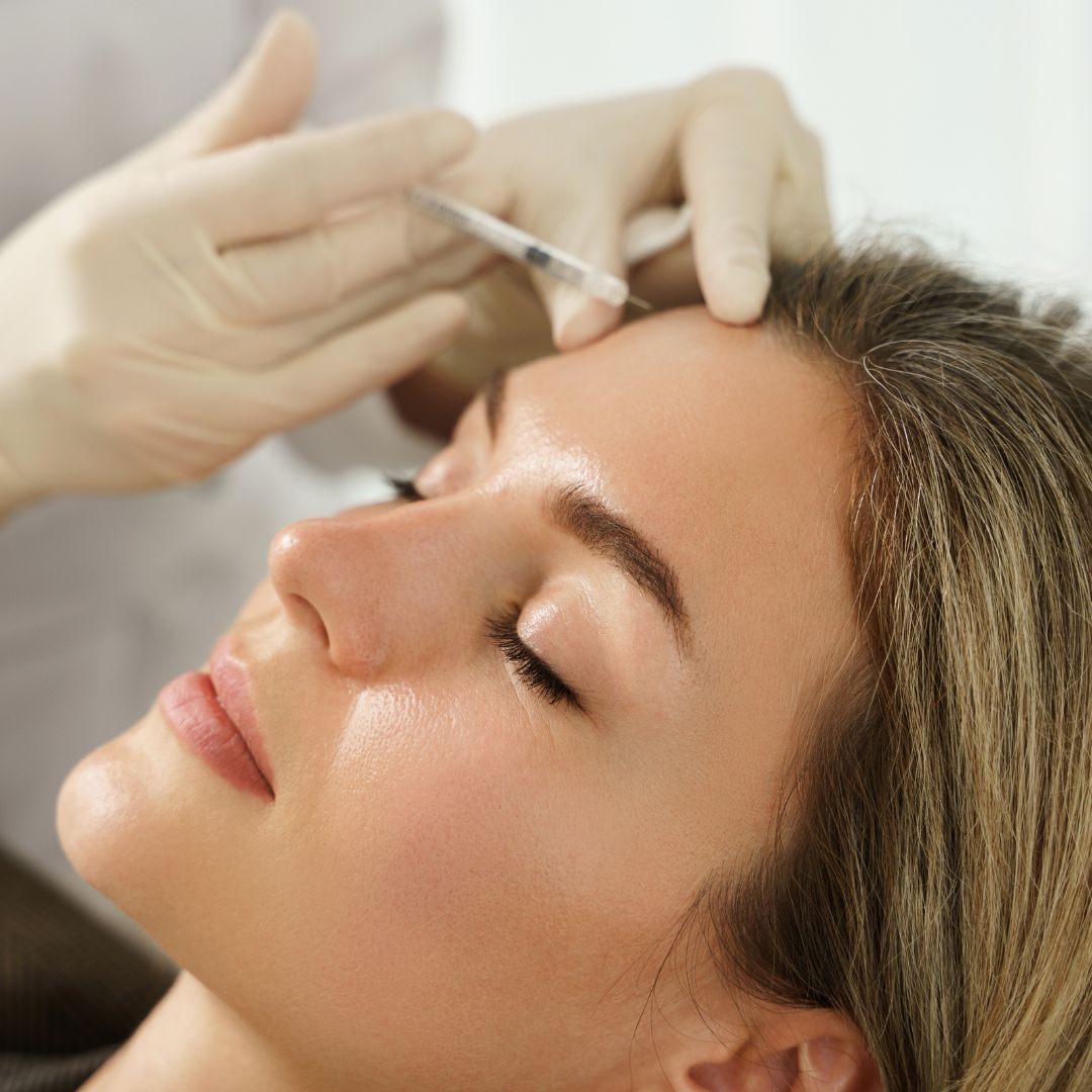 Woman getting botox in forehead
