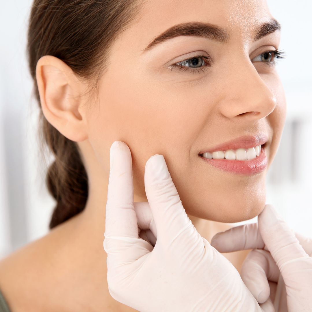 Woman with gloved hands on her face
