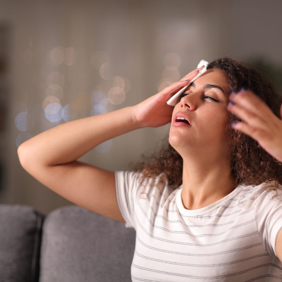 a woman wiping the sweat from her face