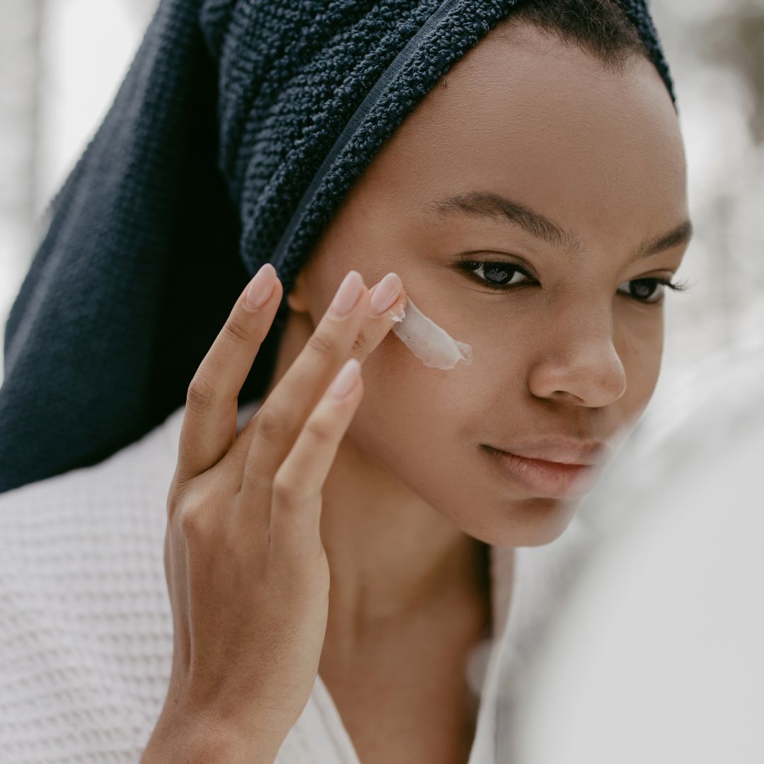 woman putting on skin cream